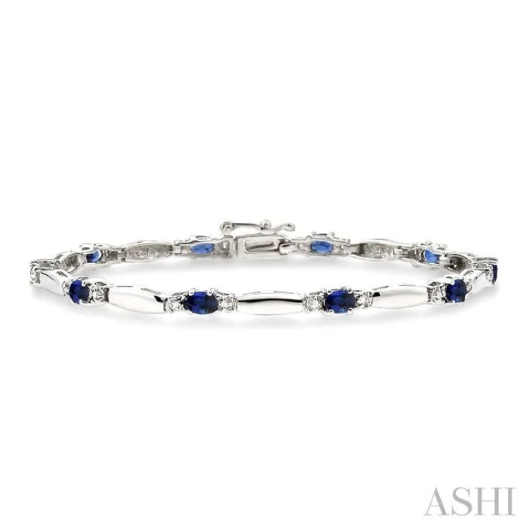 1/10 Ctw Bar and Oval Mount Round Cut Diamond & 5x3MM Oval Cut Sapphire Precious Bracelet in 10K White Gold