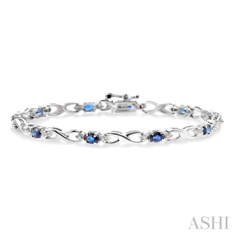 4x3 MM Oval Cut Sapphire and 1/10 Ctw Single Cut Diamond Bracelet in 10K White Gold