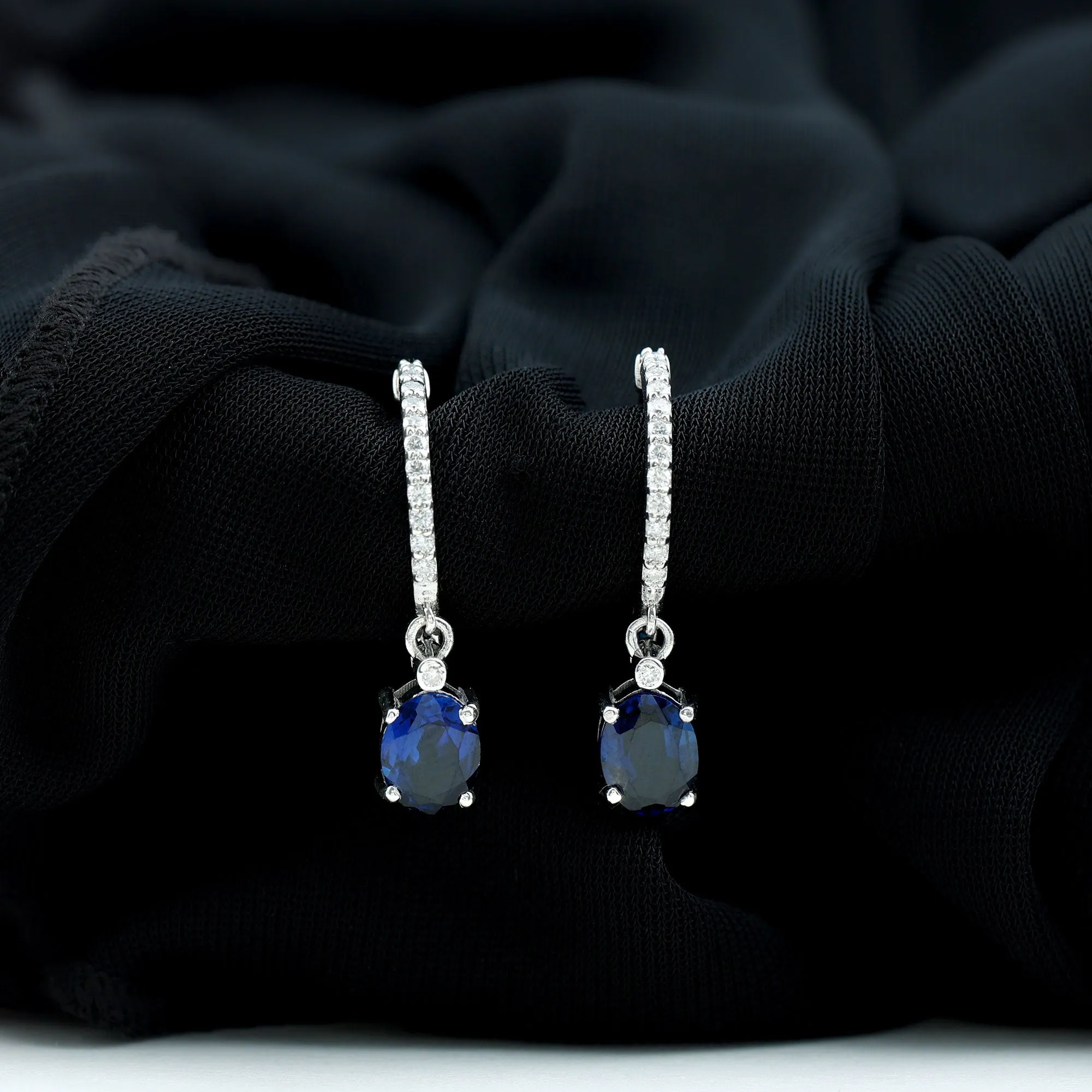 Oval Created Blue Sapphire Silver Hoop Drop Earrings with Moissanite